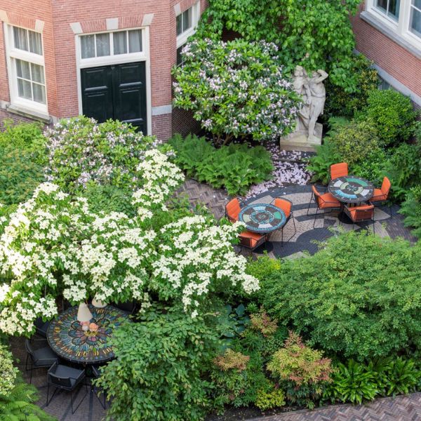 a courtyard with a table and chairs