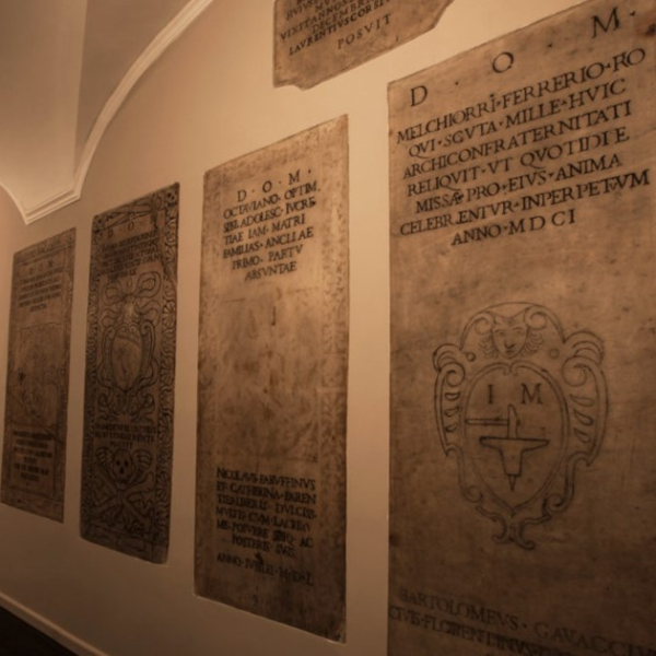 a wall with engraved stone plaques
