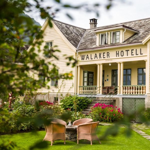 a hotel with a lawn and chairs