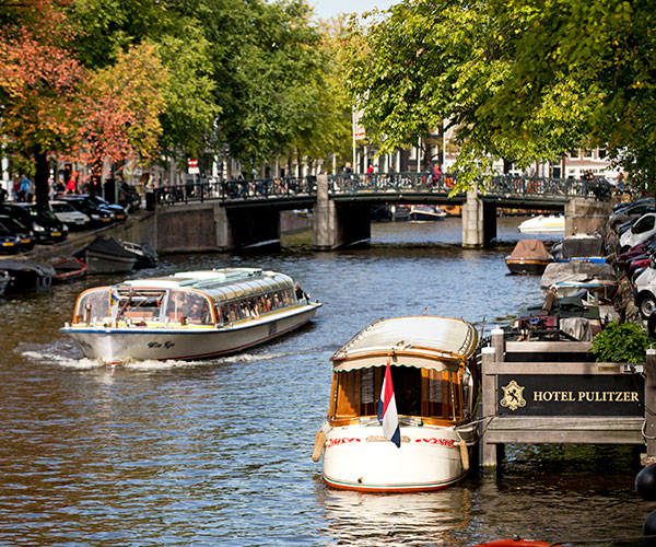 boats on a river with a bridge and boats