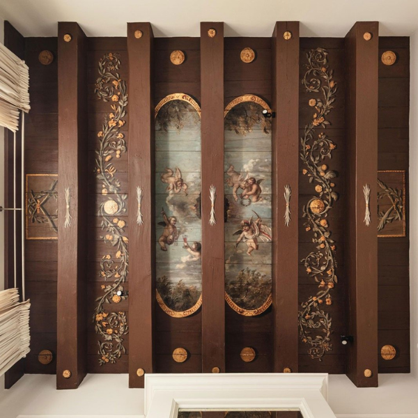 a wood paneled ceiling with paintings on it
