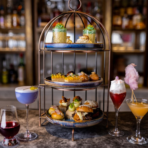 a three tiered tray with food on it
