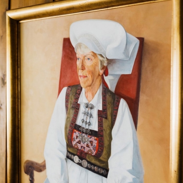 a painting of a woman in a gold frame