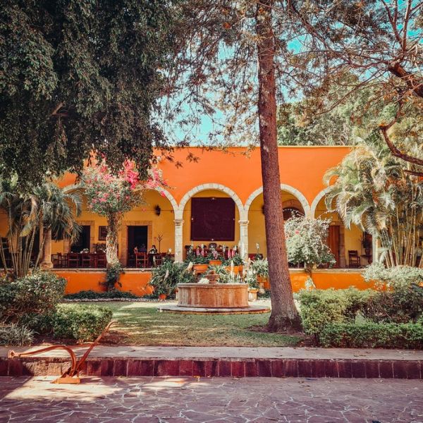 a building with a fountain and trees