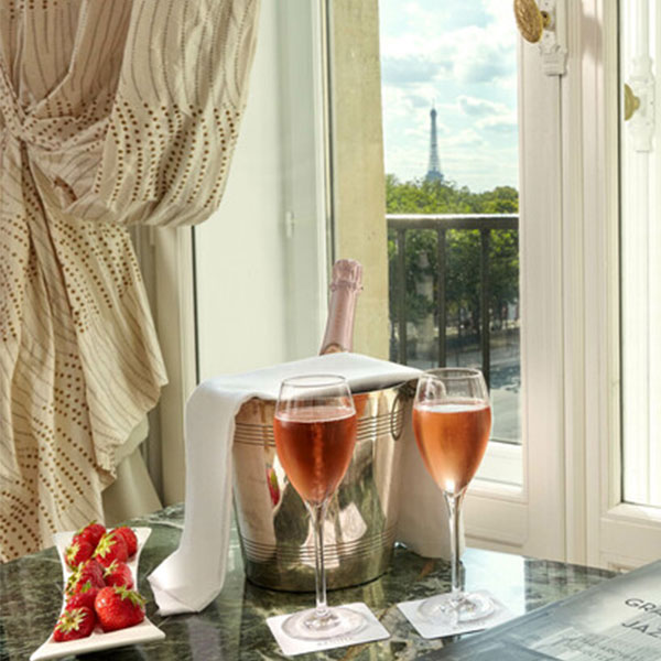 a glass of wine and strawberries on a table