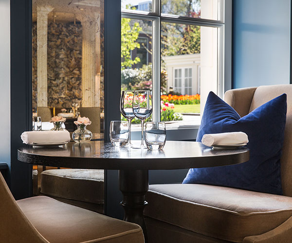 a table with glasses and a blue pillow