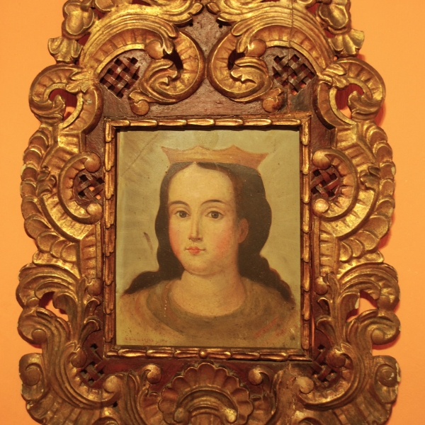 a painting of a woman in a gold frame