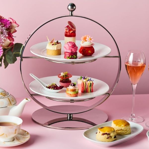 a tray of desserts and a glass of wine