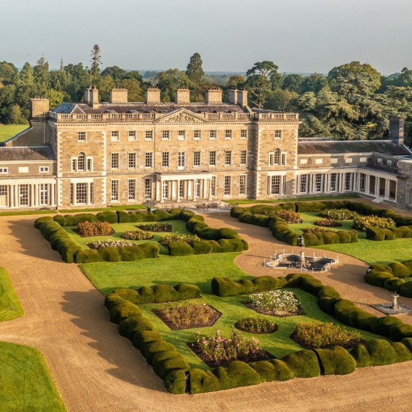 a large building with a garden and a fountain