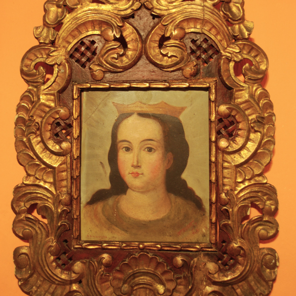a painting of a woman in a gold frame