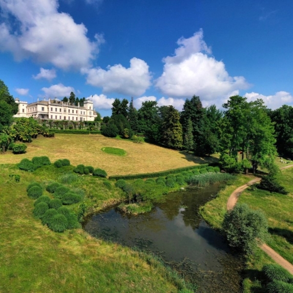 a white building with a river in front of it