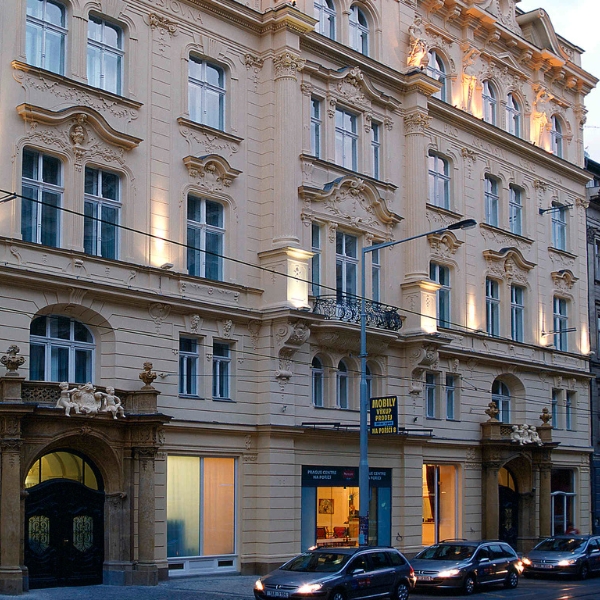 a building with many windows and cars parked on the street