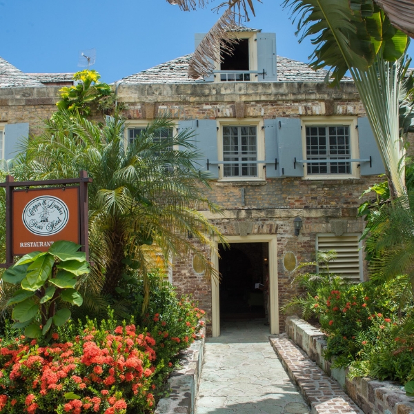 a building with a clock and flowers