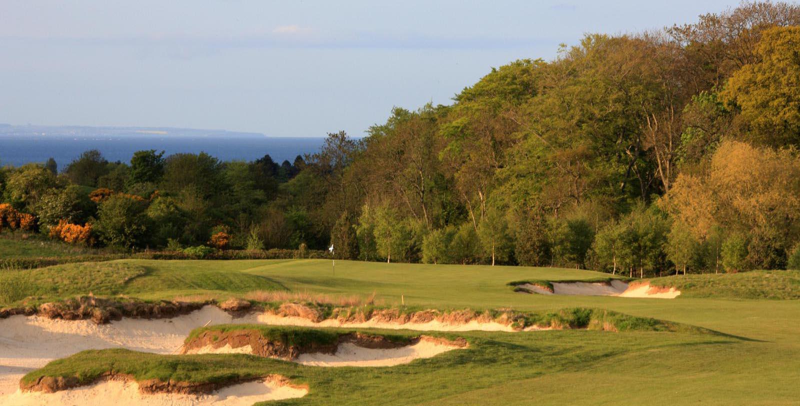 a golf course with sand bunkers 24