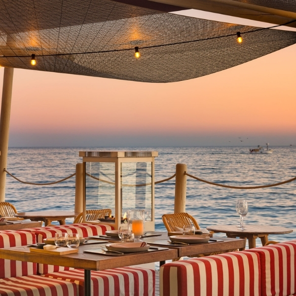 a table and chairs on a beach