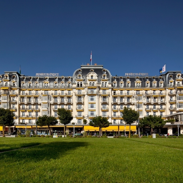 a large building with many windows and a lawn