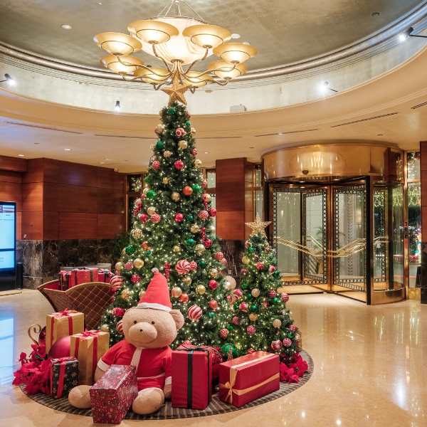 a christmas tree with presents and a teddy bear