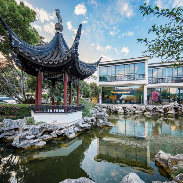 a building with a pond and a gazebo
