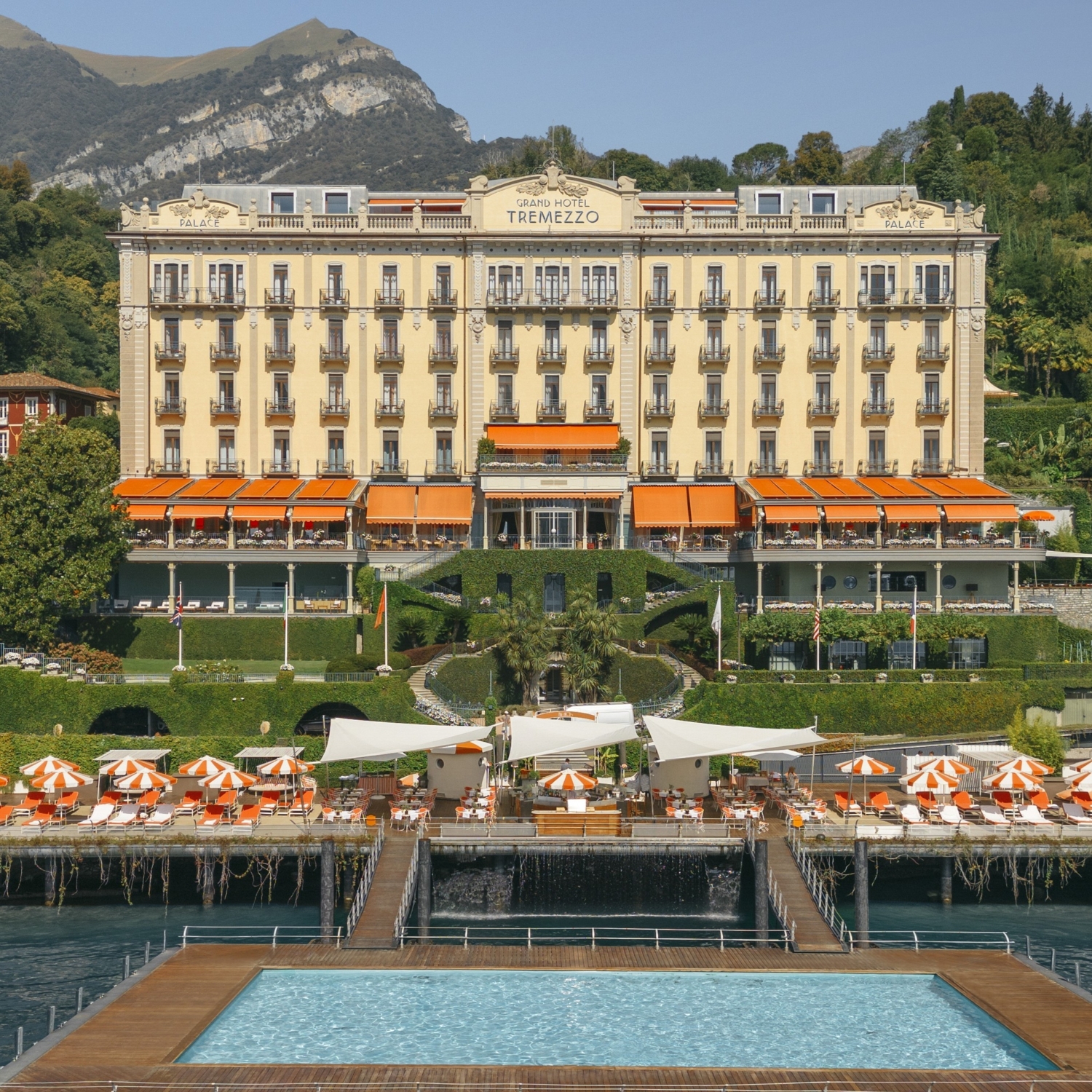 a large building with a pool and a walkway