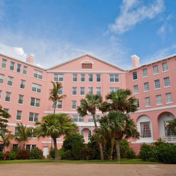 a pink building with palm trees