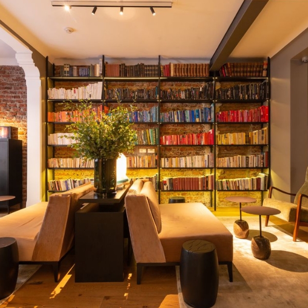 a room with a book shelf and couches