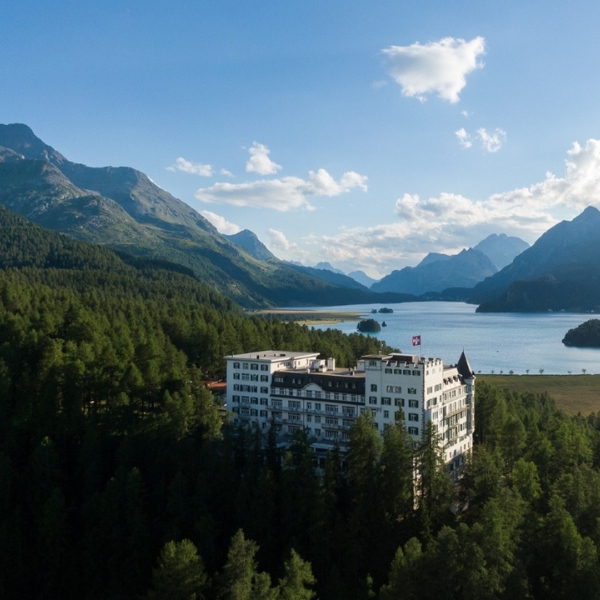 a building surrounded by trees and mountains