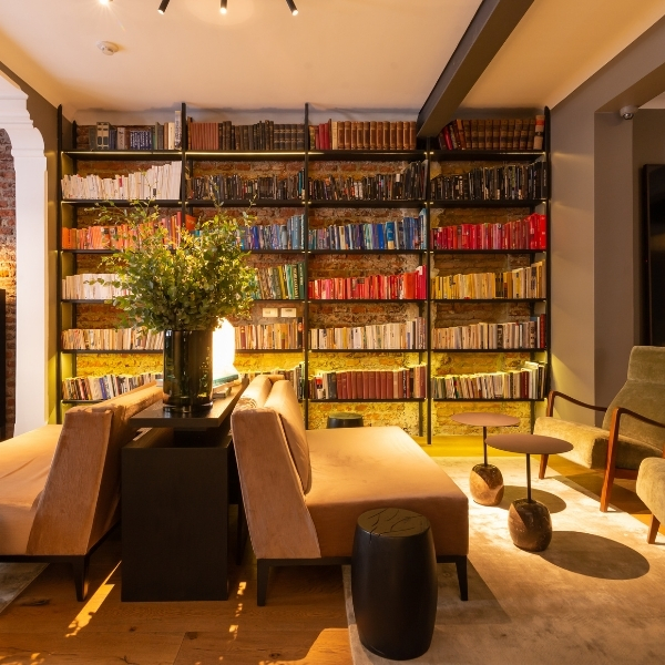 a room with a book shelf and couches