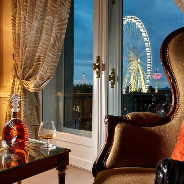 a room with a chair and a table with a ferris wheel in the background