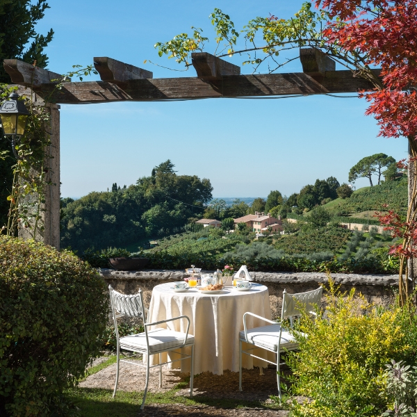 a table and chairs under a pergola