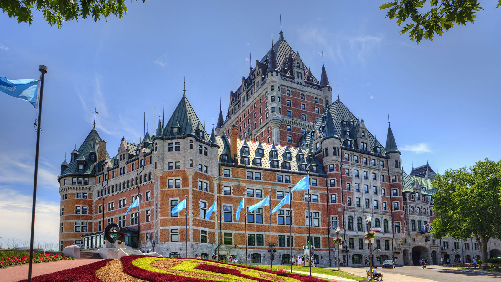 a large building with many windows with Château Frontenac in the background 19