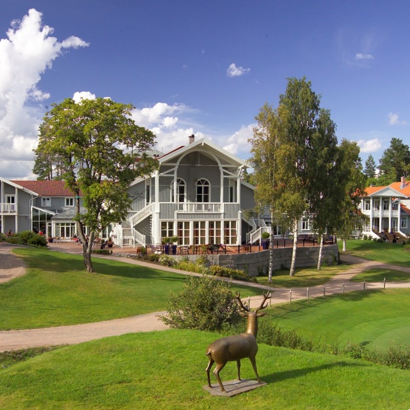a large building with a statue of a deer in front of it