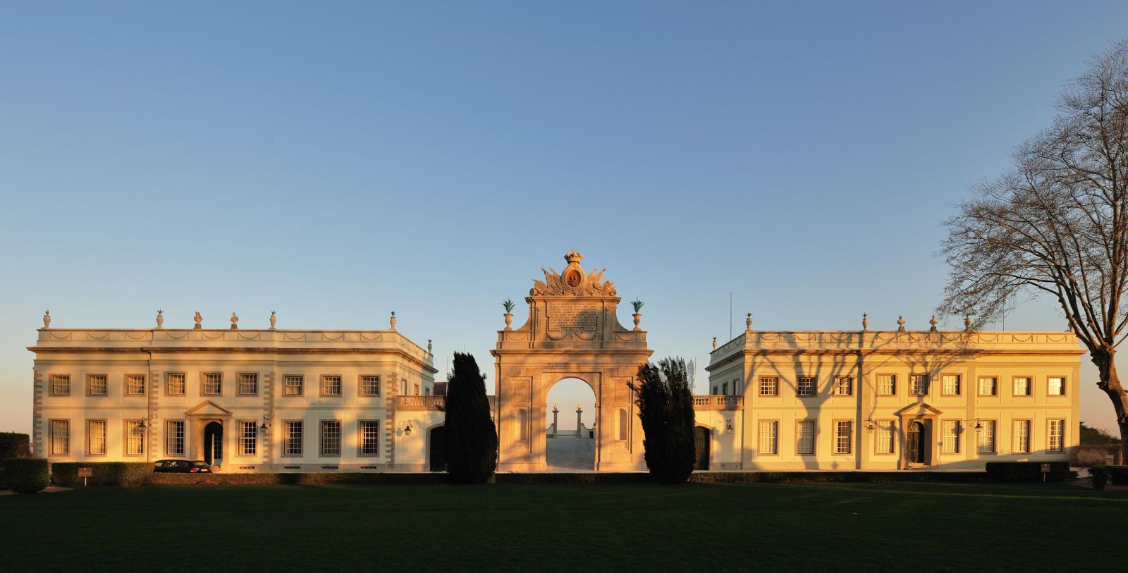 a large white building with a large archway 4