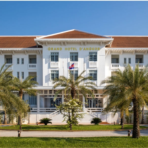 a white building with palm trees