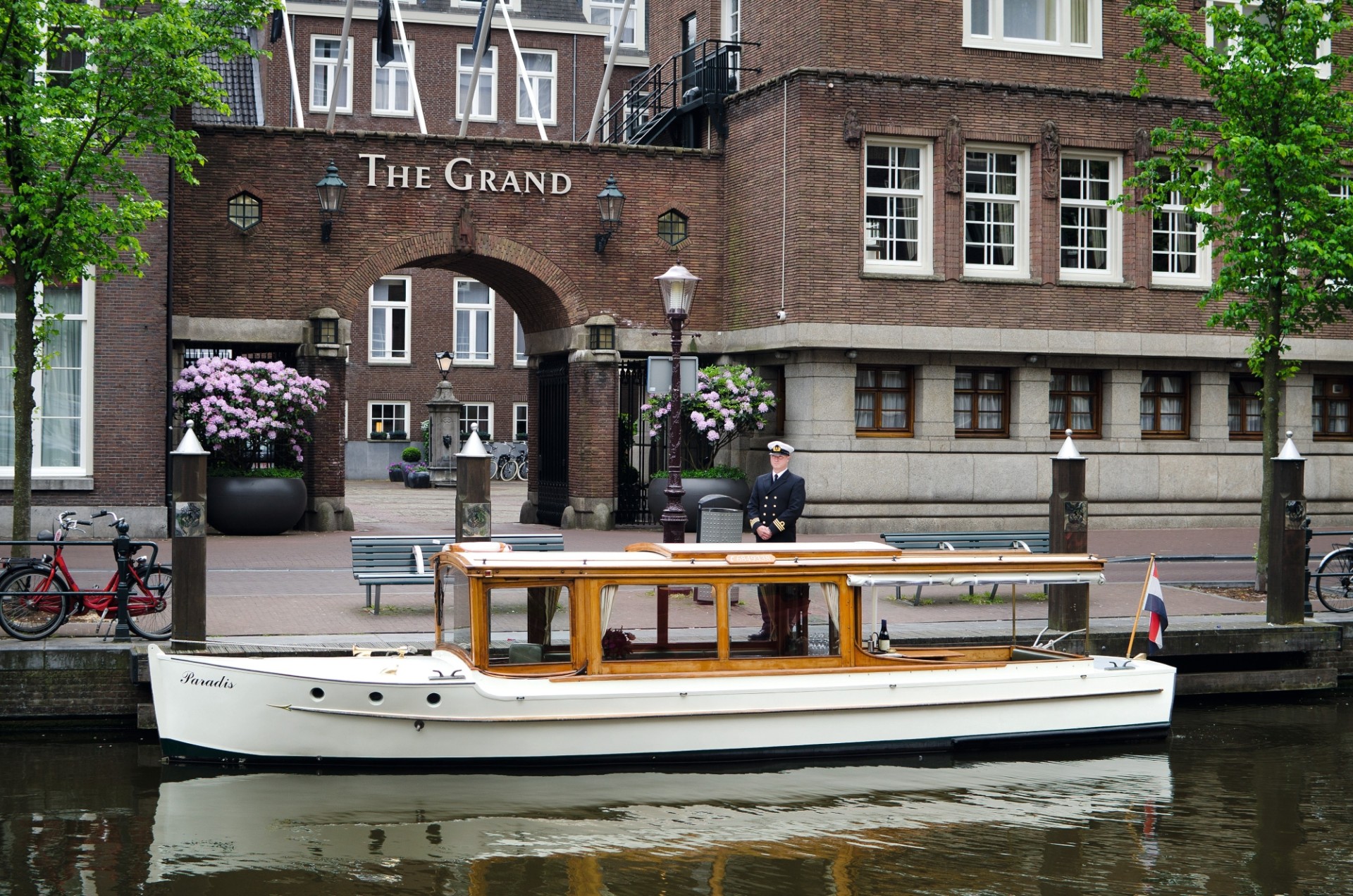 a man standing on a boat in a canal