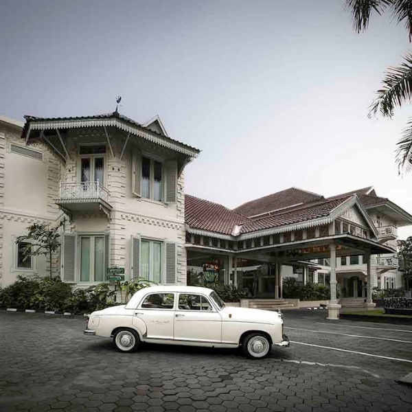 a white car parked in front of a building