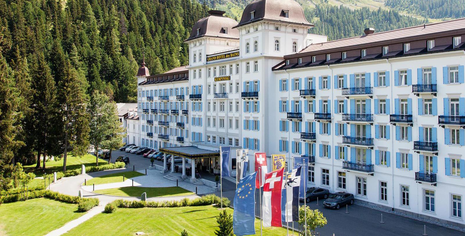 a large white building with flags in front of it 11