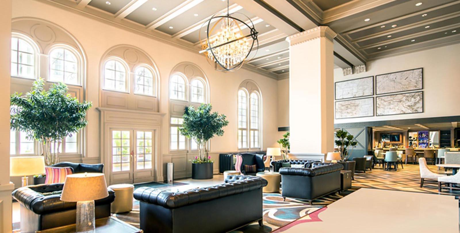 a room with a chandelier and couches