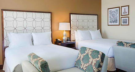 a room with two beds and a lamp