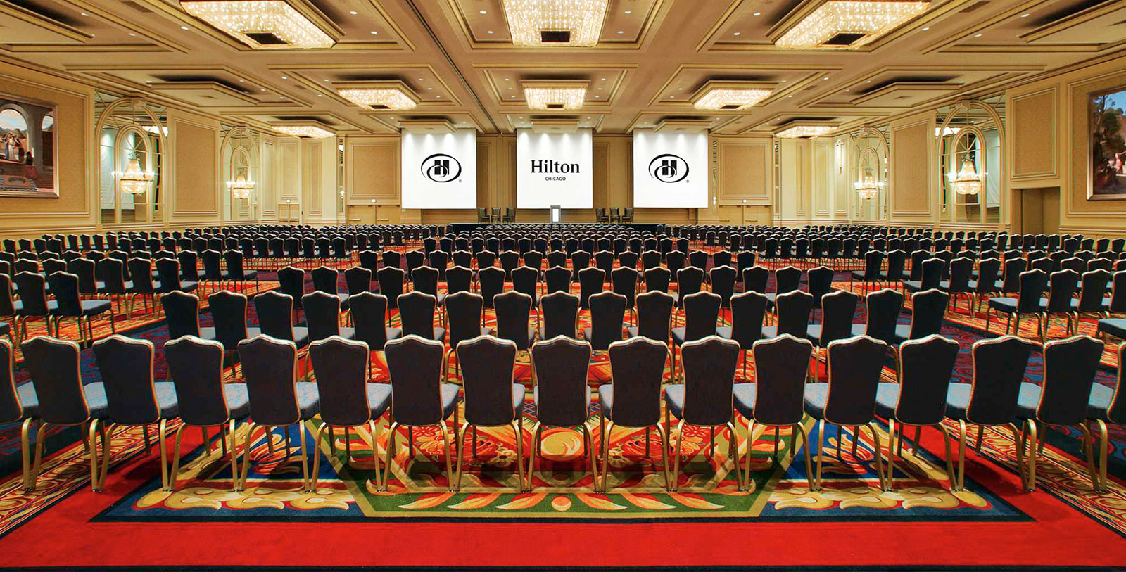 a large room with chairs and a screen