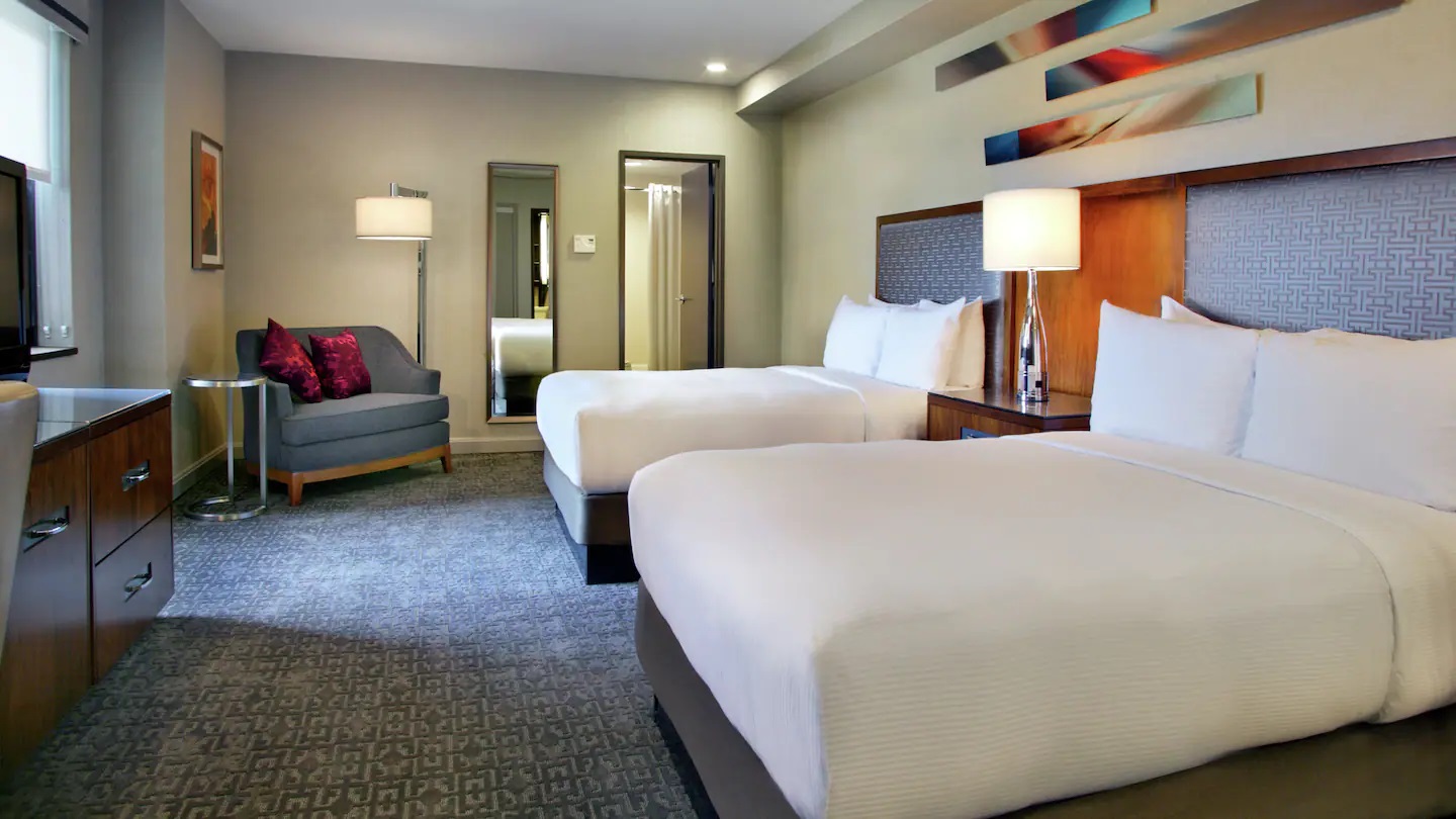 a room with two beds and a couch