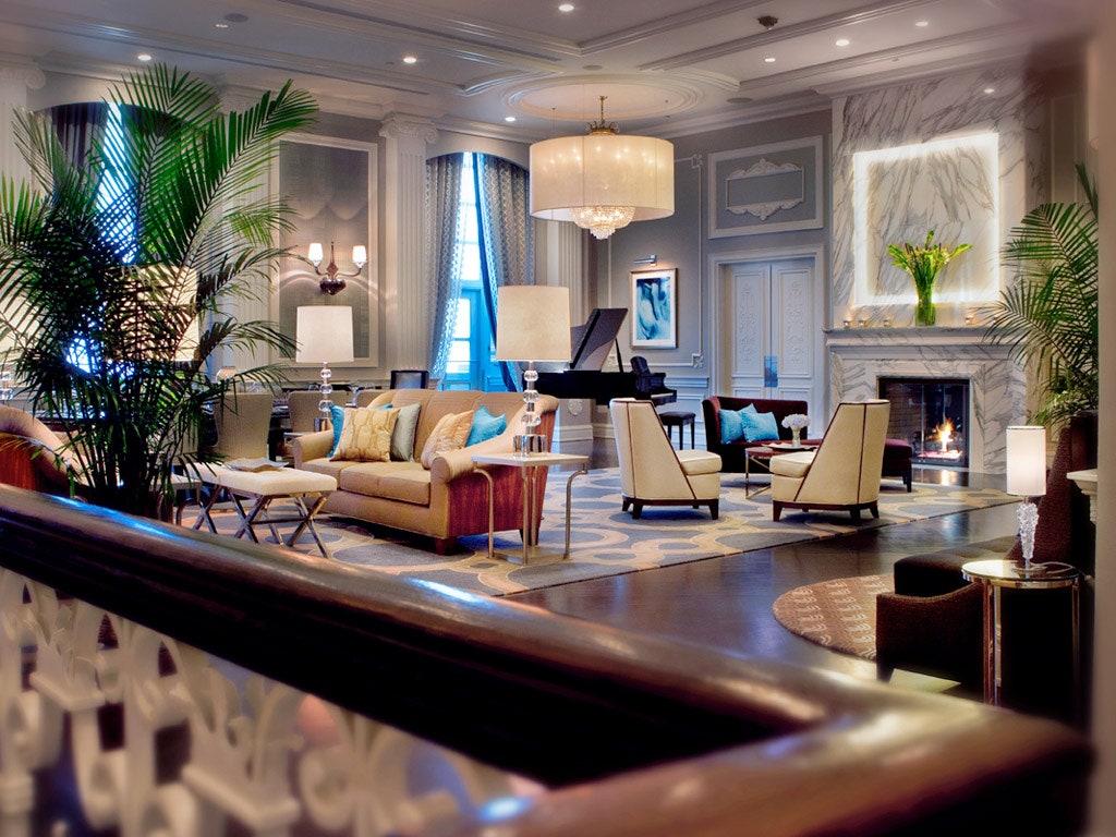 a living room with a piano and couches
