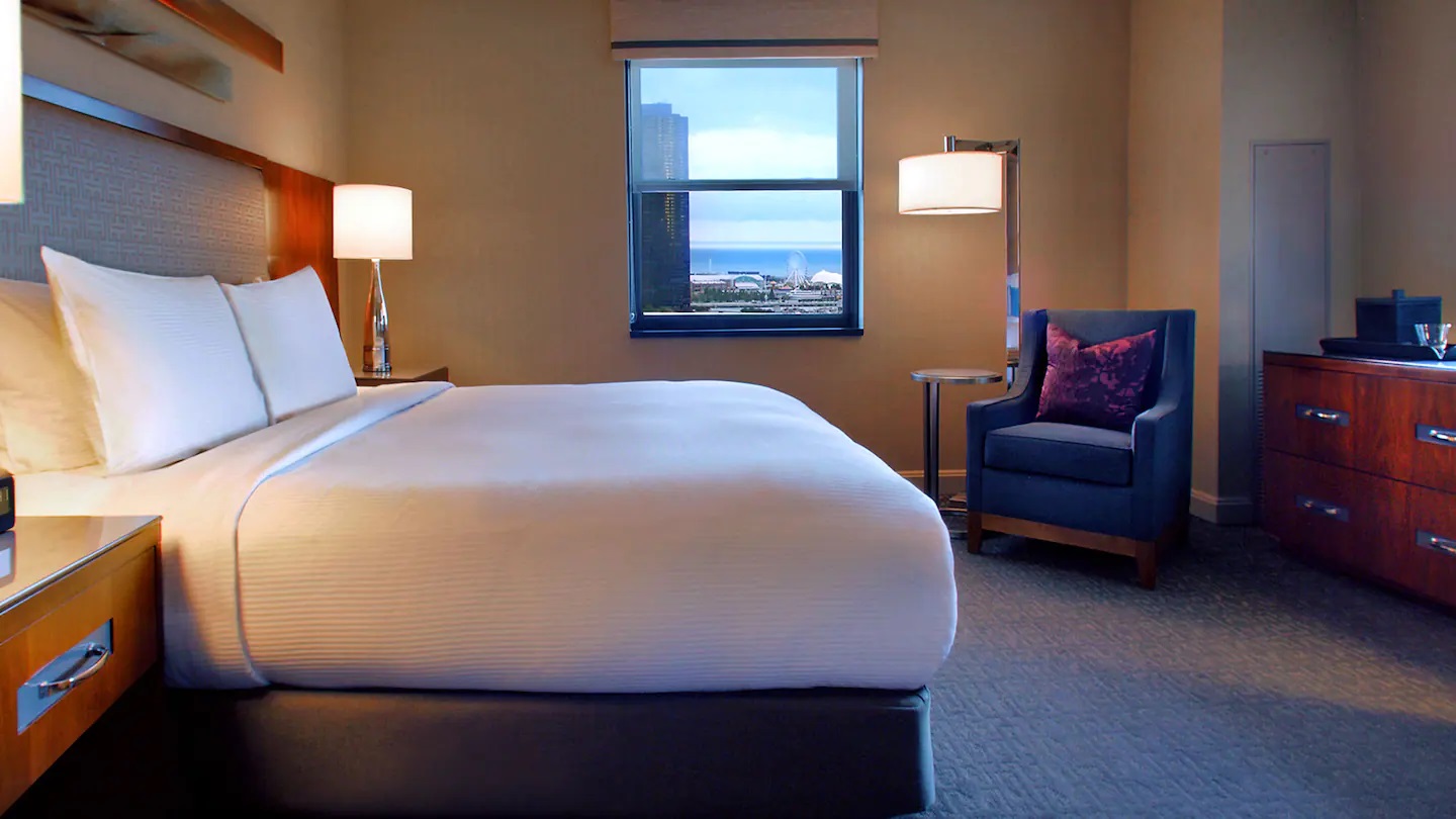 a hotel room with a bed and a chair