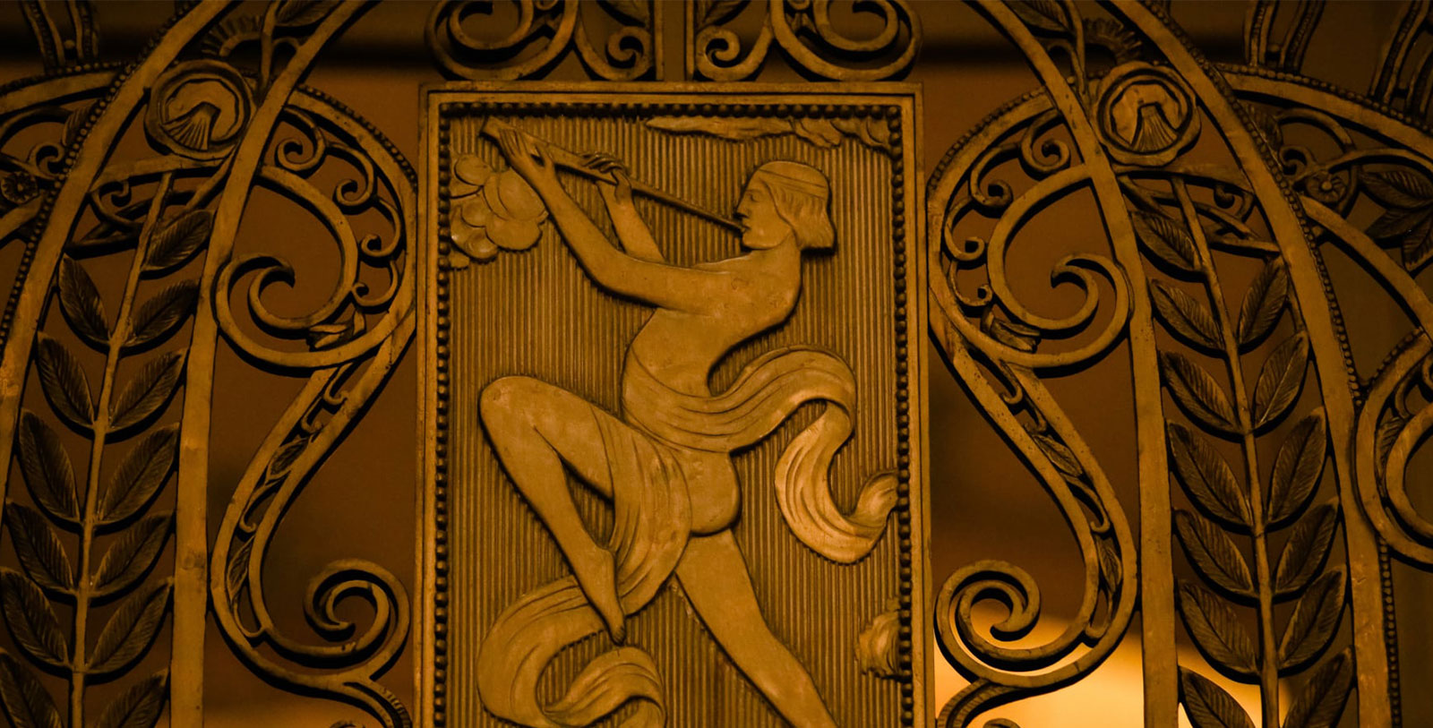a sculpture of a woman playing a flute