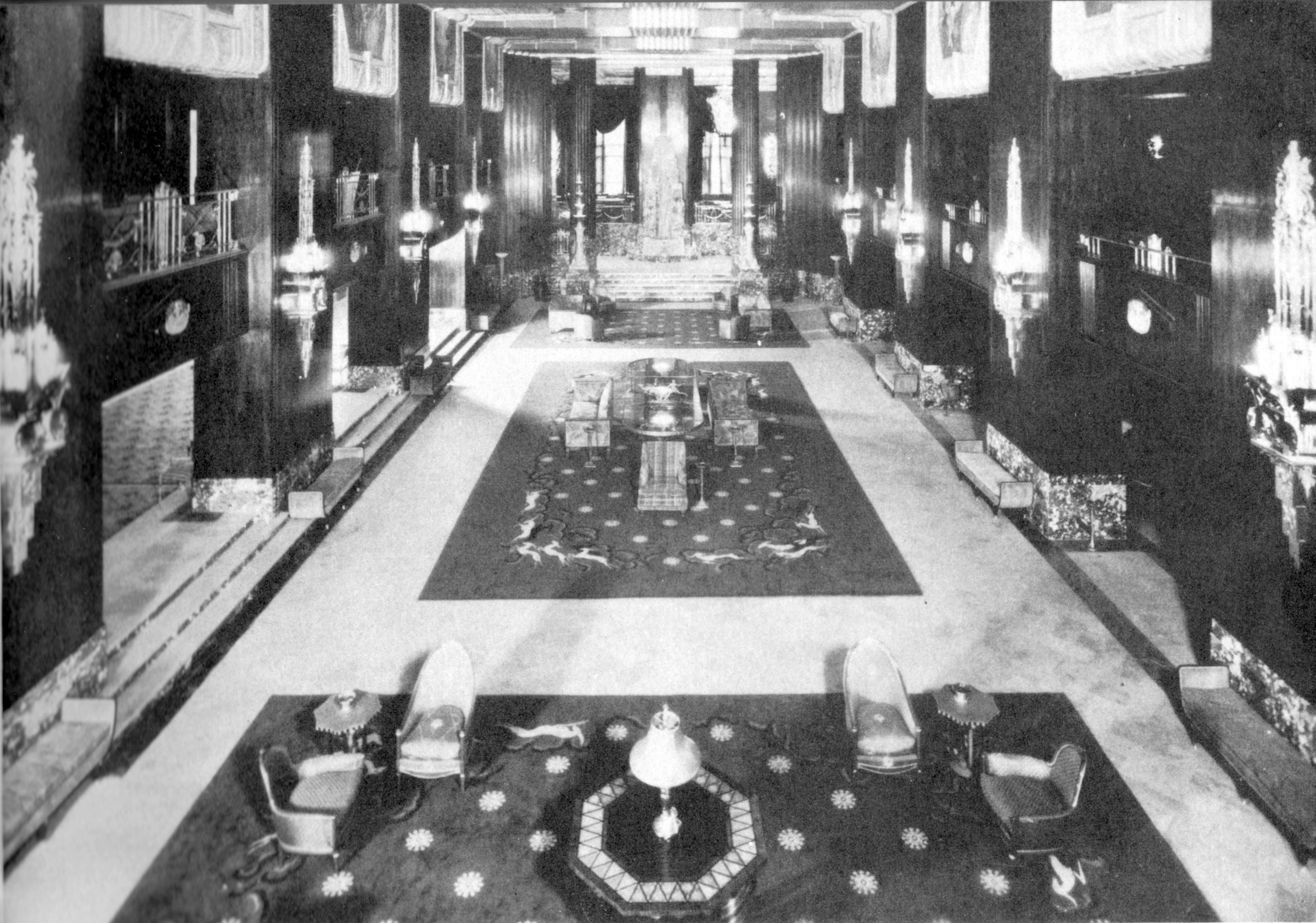 a large room with a large carpet and chairs