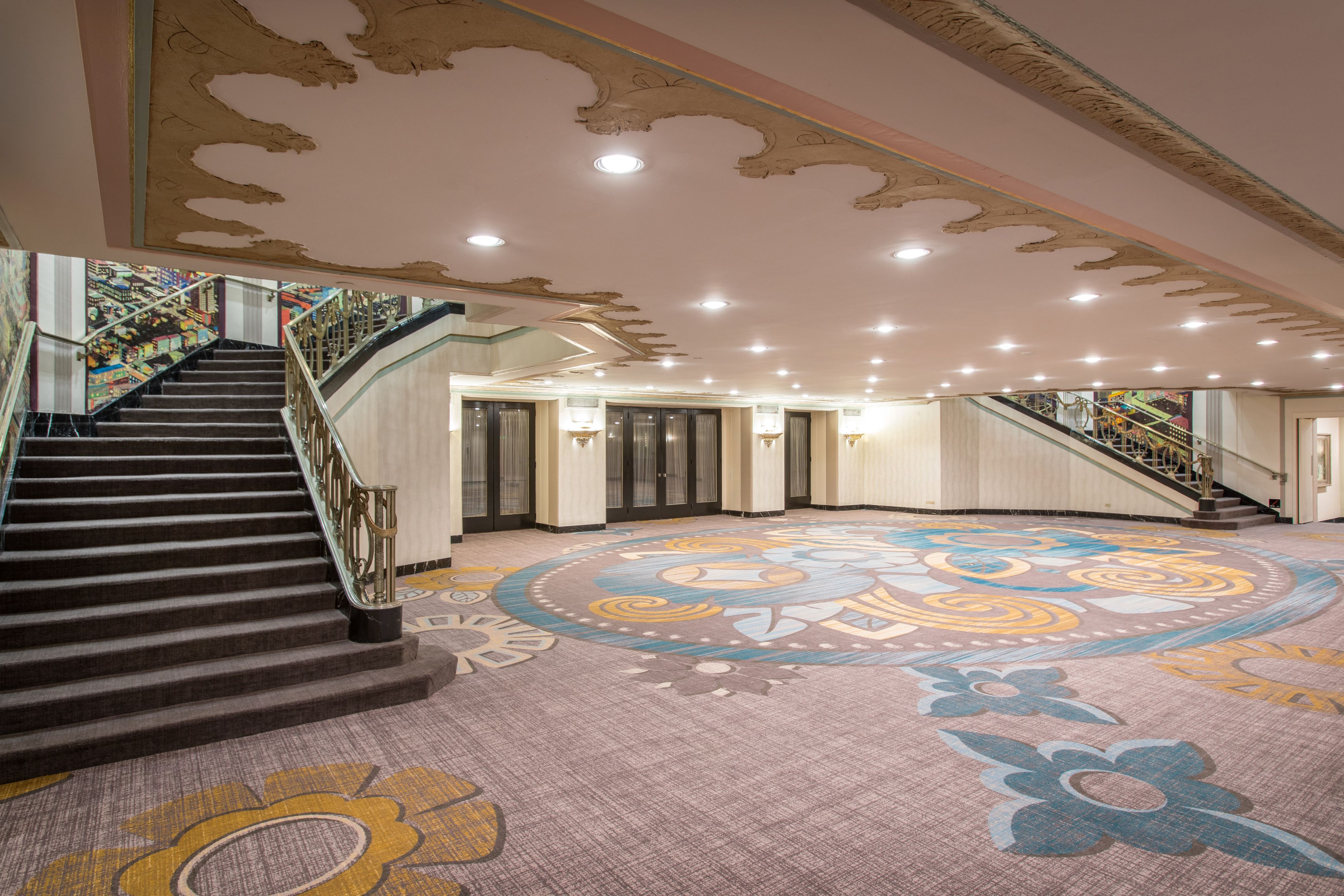 a large room with stairs and carpet