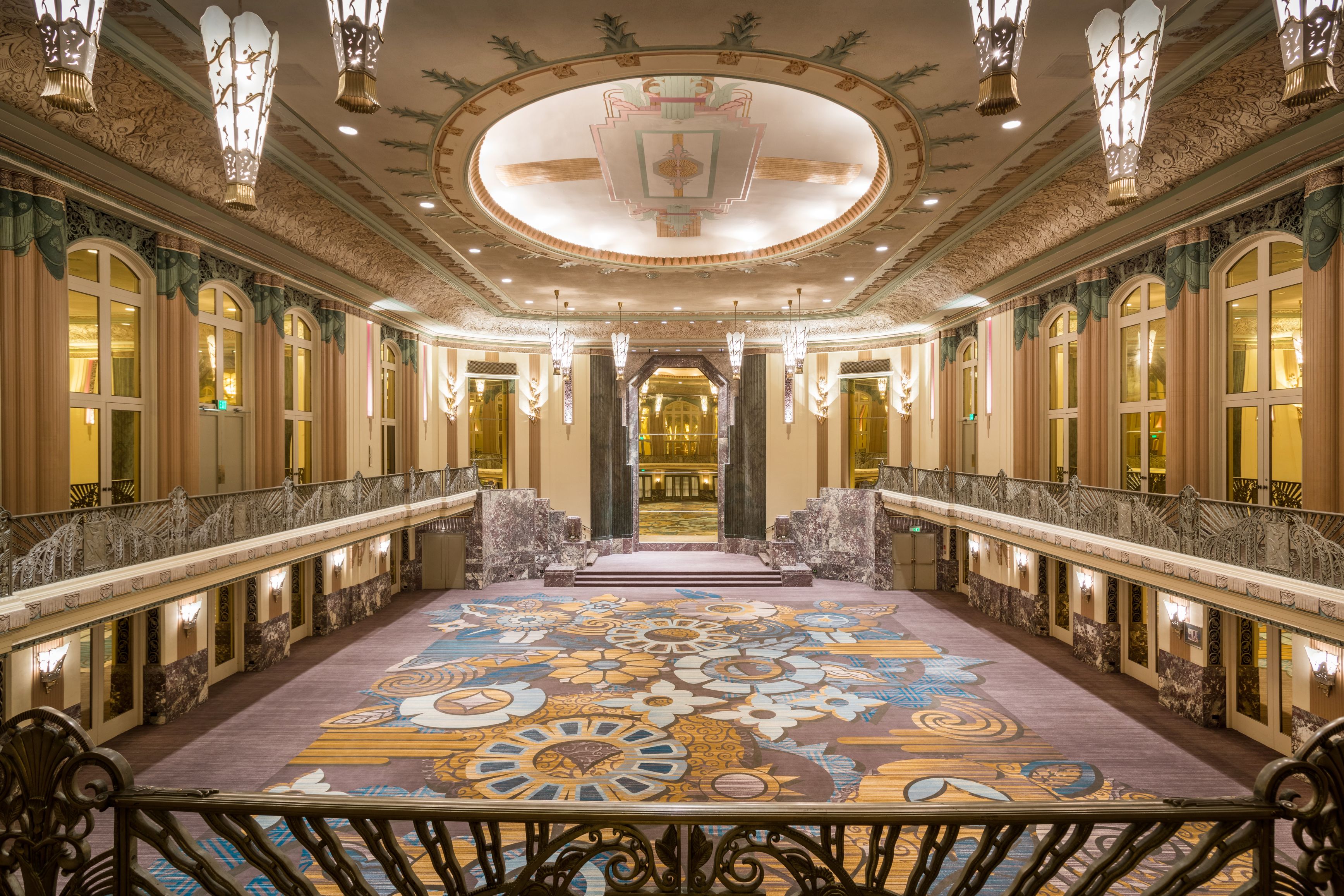 a large ornate room with a balcony and a large ceiling