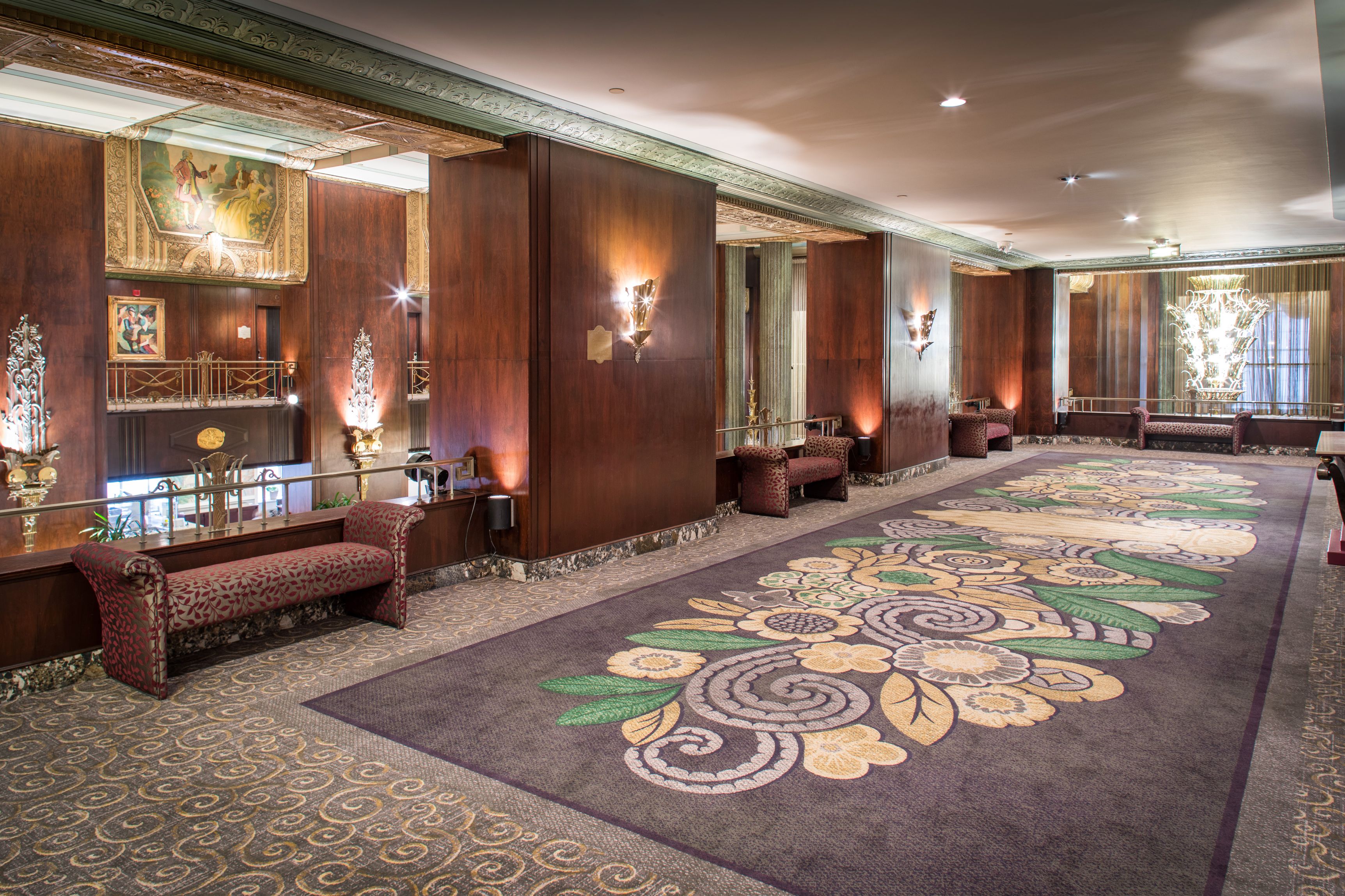 a large room with a carpet and benches