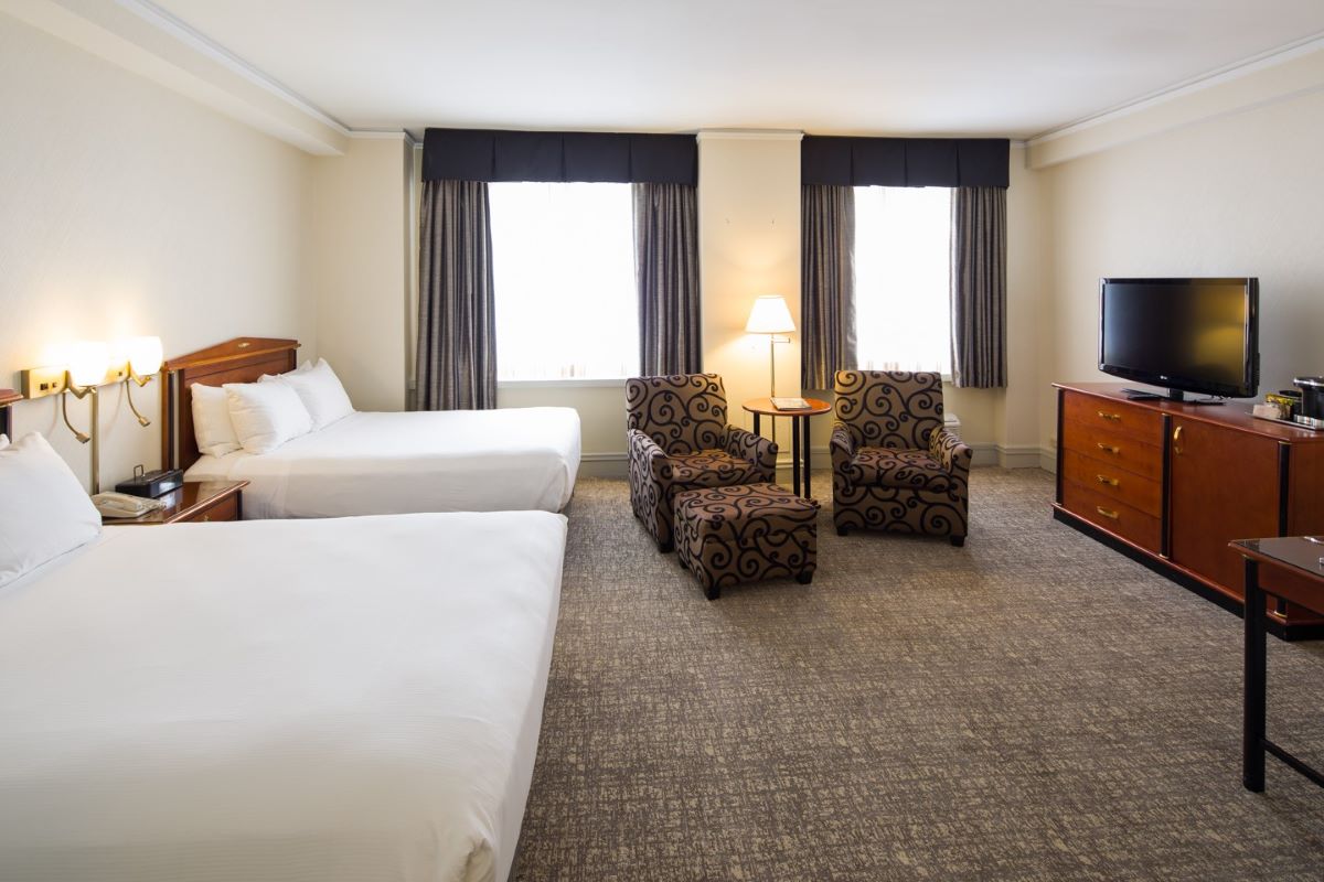 a room with two beds and a tv