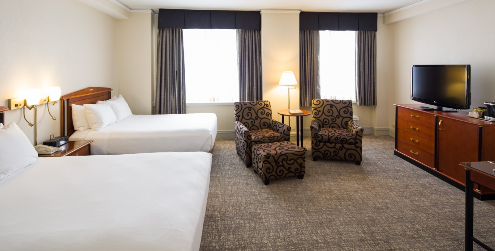 a room with two beds and a lamp