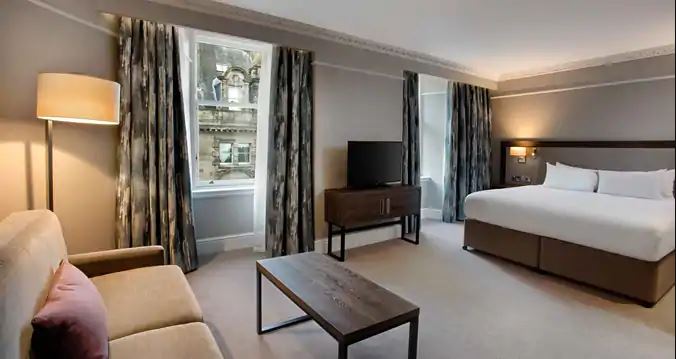 a room with a bed and a television